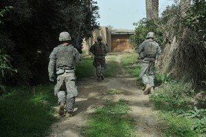 army walking through a grassy alley