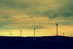 wind turbine silhouettes against a yellow sky